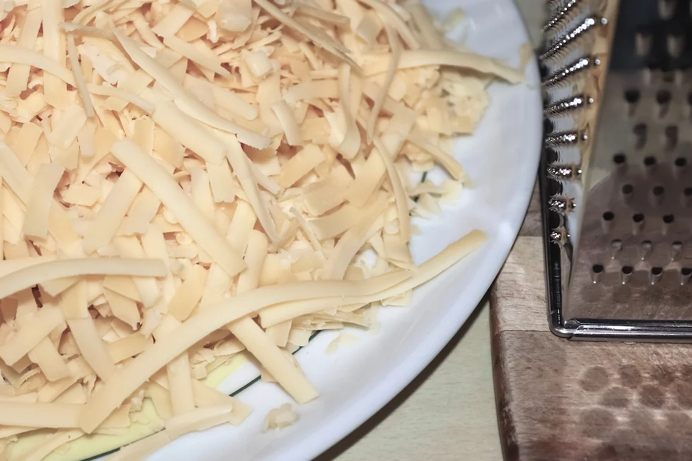 Close up of fresh chopped cheese as topping for a pizza.